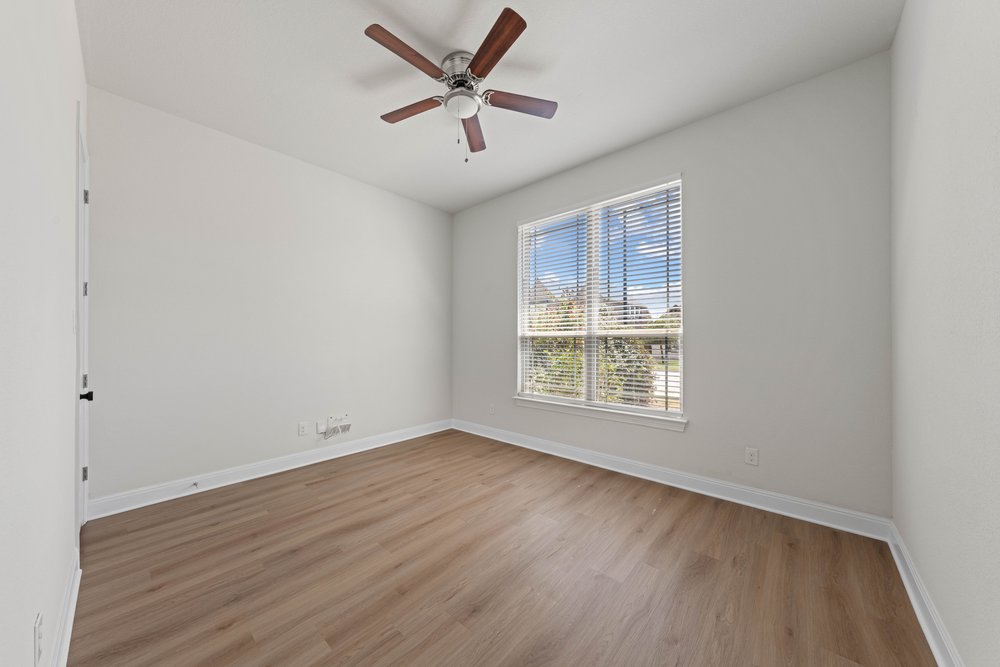 4208 Brean Down Road Pflugerville, TX 78660 - Photo 24 of 31 Warm wood-style flooring and a large multi-pane window define this versatile interior room.