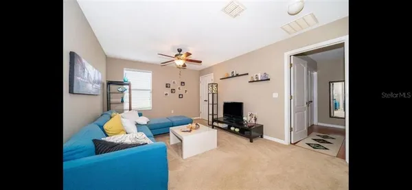 a view of a livingroom with furniture and a flat screen tv