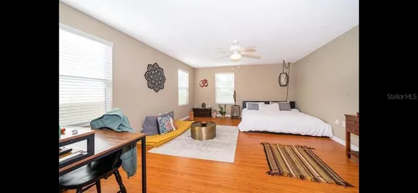 a living room with furniture and a wooden floor