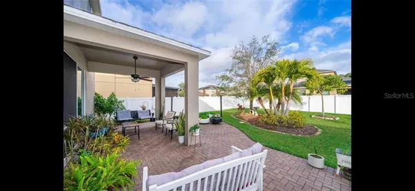 a view of a porch with plants and a yard