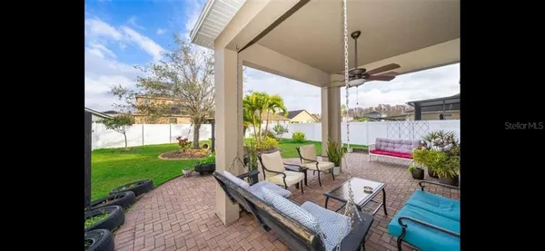 a view of a patio with a table chairs and a backyard