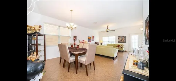 a dining room with furniture and a chandelier