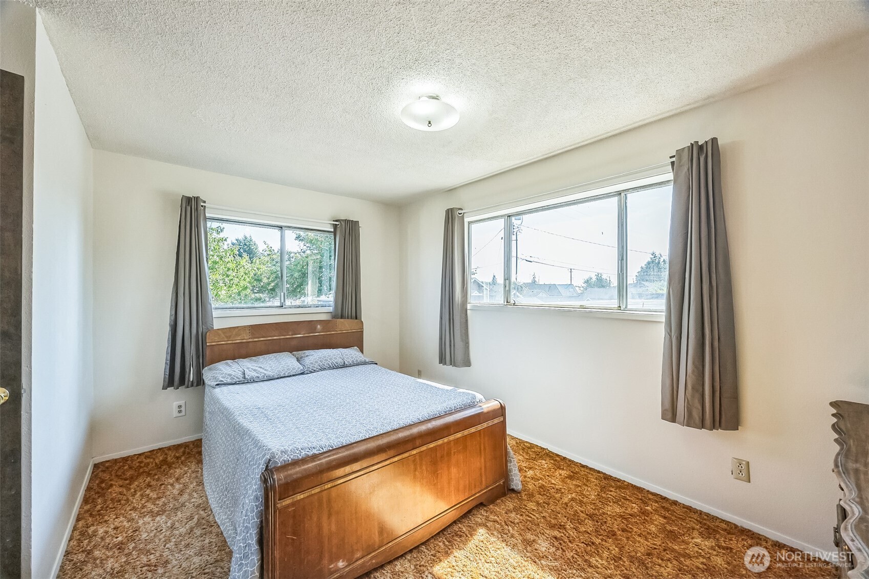 2420 Simpson Avenue Hoquiam, WA 98550 - Photo 16 of 32 a living room with a bed furniture and a window