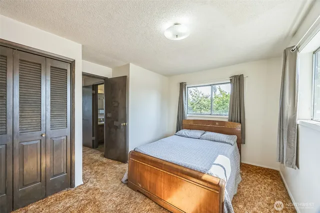 a room with a balcony a bed and furniture