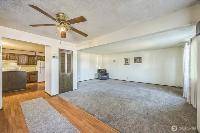 a view of a hallway with a dining table & cabinetry