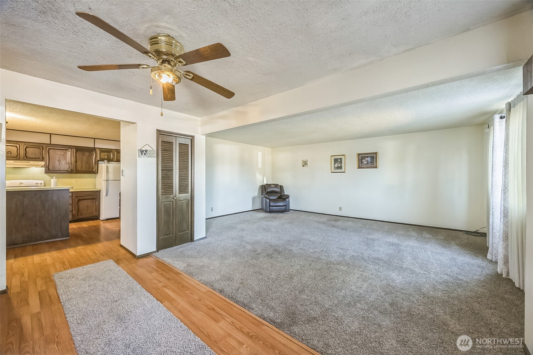 2420 Simpson Avenue Hoquiam, WA 98550 - Photo 23 of 32 a view of a hallway with a dining table & cabinetry
