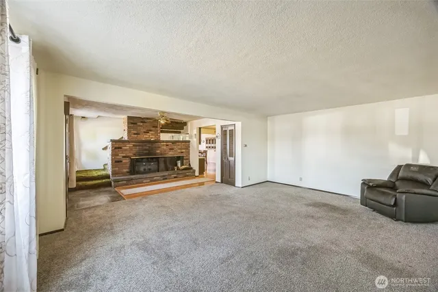 a view of empty room with a fireplace