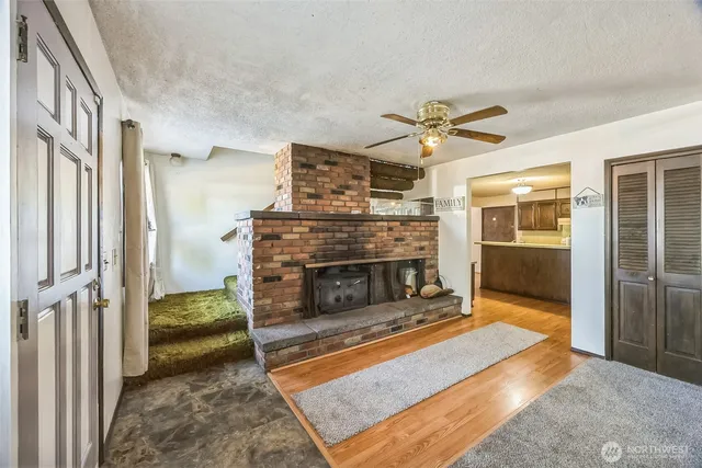 a living room with furniture a fireplace and a chandelier