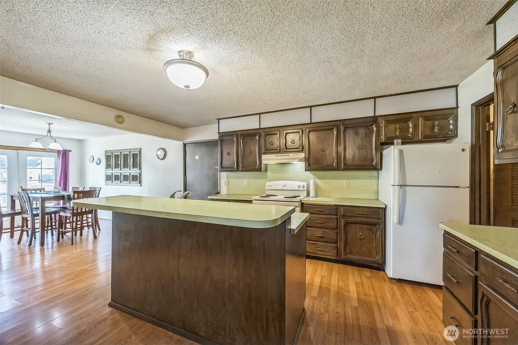 2420 Simpson Avenue Hoquiam, WA 98550 - Photo 9 of 32 a kitchen with stainless steel appliances granite countertop a refrigerator a stove and a wooden floors
