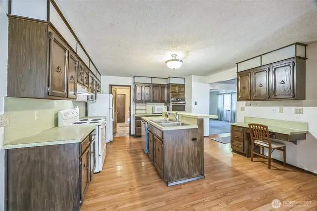 a kitchen with stainless steel appliances granite countertop a stove and cabinets