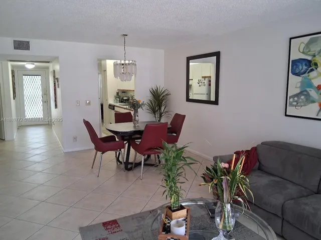 a view of a livingroom with furniture and a potted plant