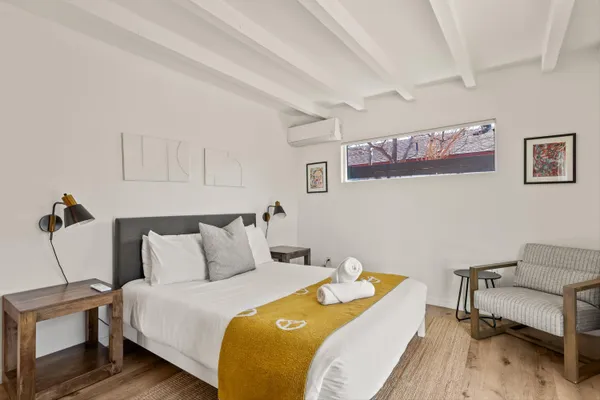 a bedroom with a bed and wooden floor