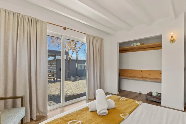 a bedroom with a bed and glass door