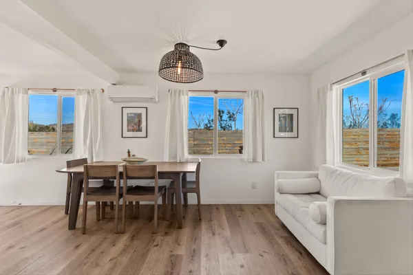 a view of a dining room with furniture window and wooden floor