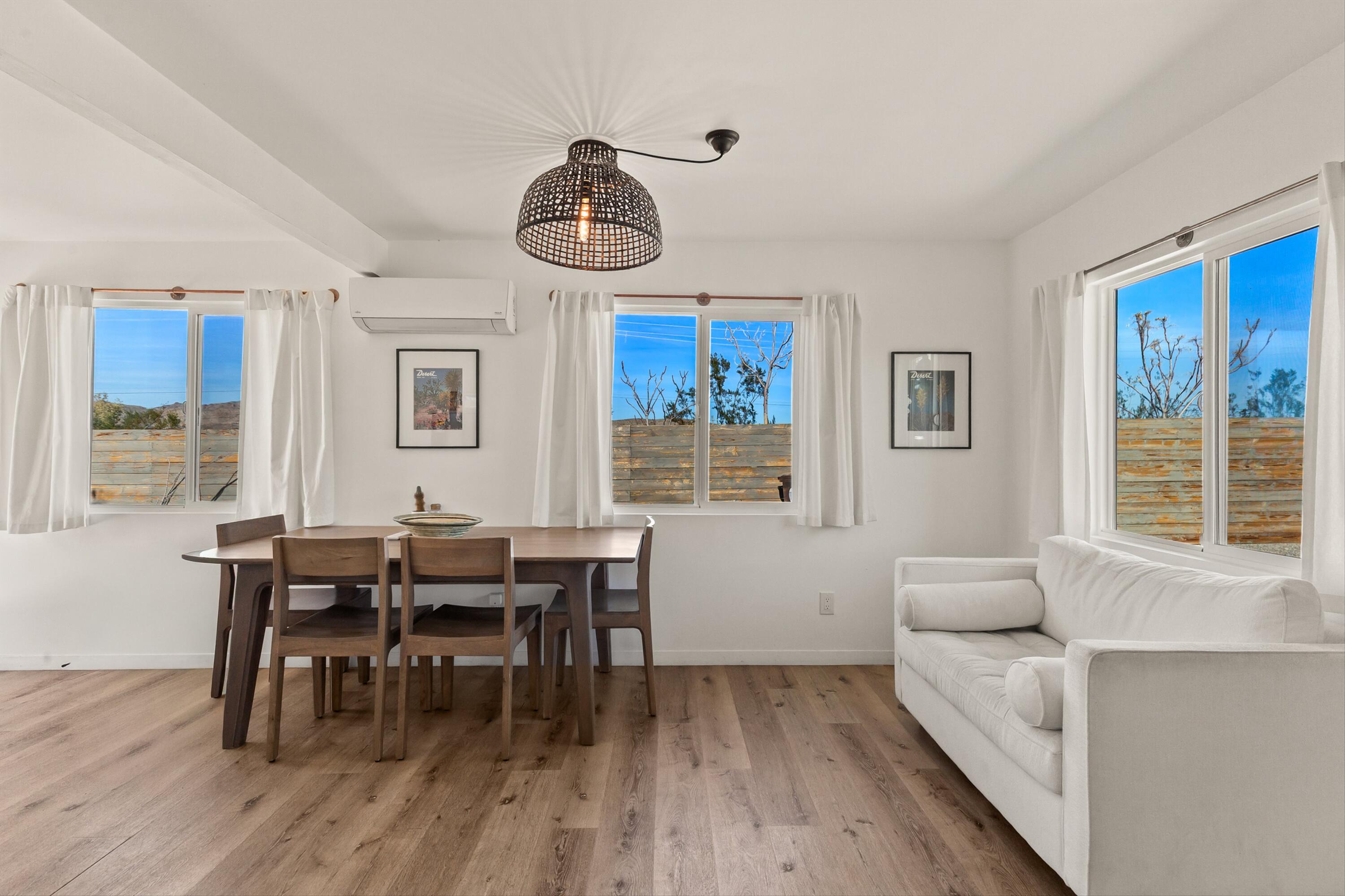 62010 El Reposo Circle Joshua Tree, CA 92252 - Photo 13 of 28 a view of a dining room with furniture window and wooden floor