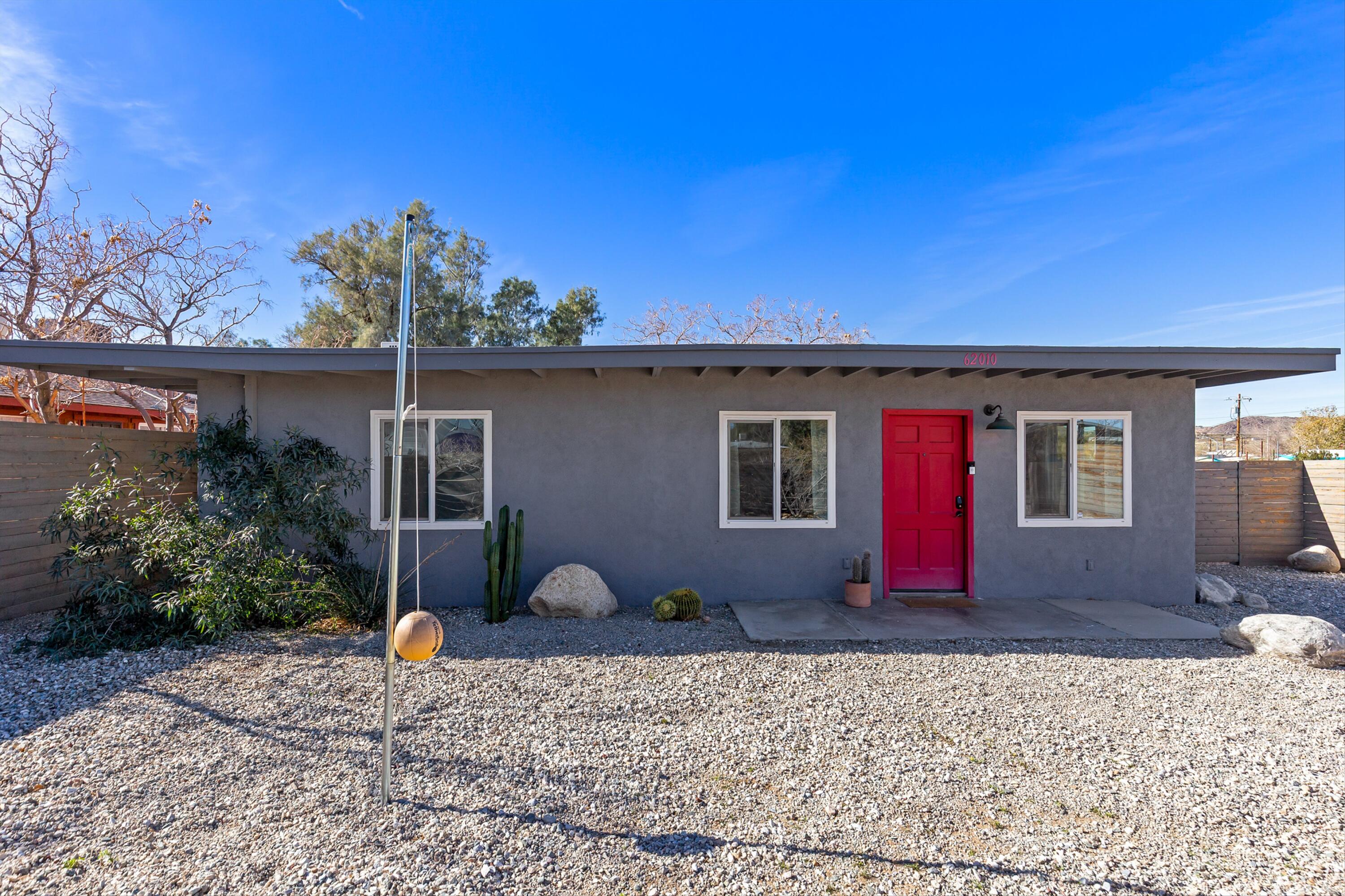 62010 El Reposo Circle Joshua Tree, CA 92252 - Photo 2 of 28 a front view of a house with garden