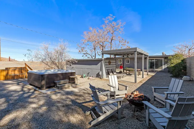 a view of a patio with table and chairs with wooden floor and fence