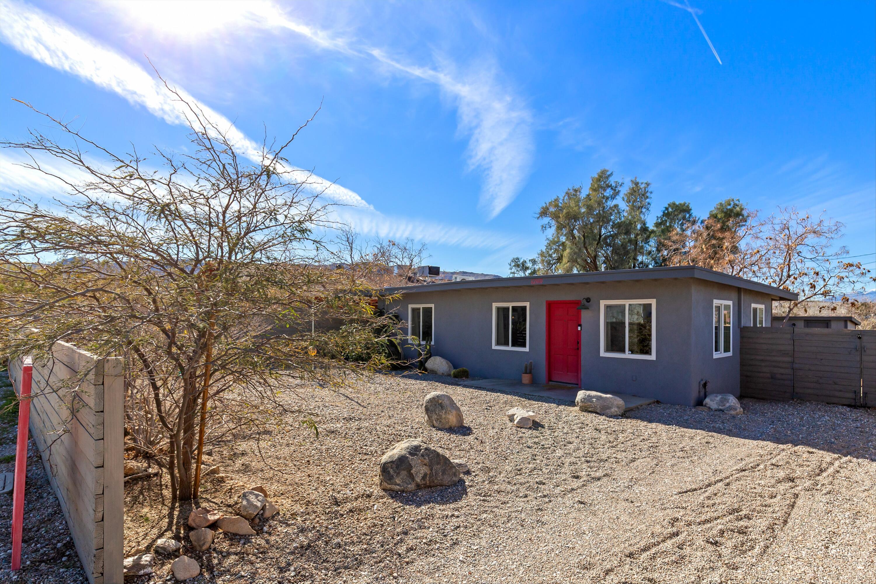 62010 El Reposo Circle Joshua Tree, CA 92252 - Photo 27 of 28 a front view of a house with a yard