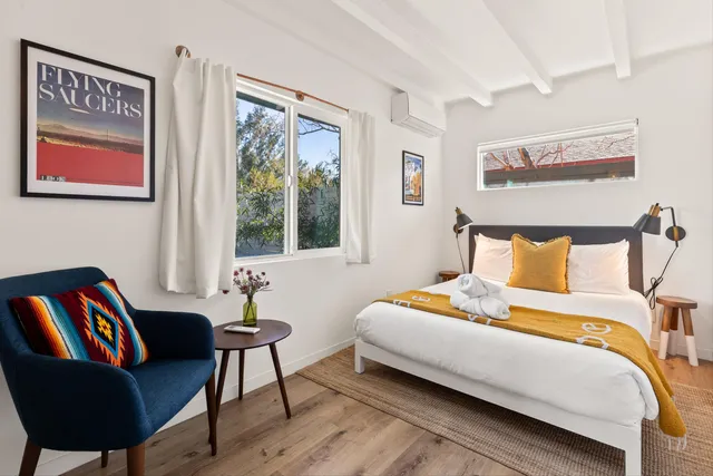 a bedroom with a bed and a couch