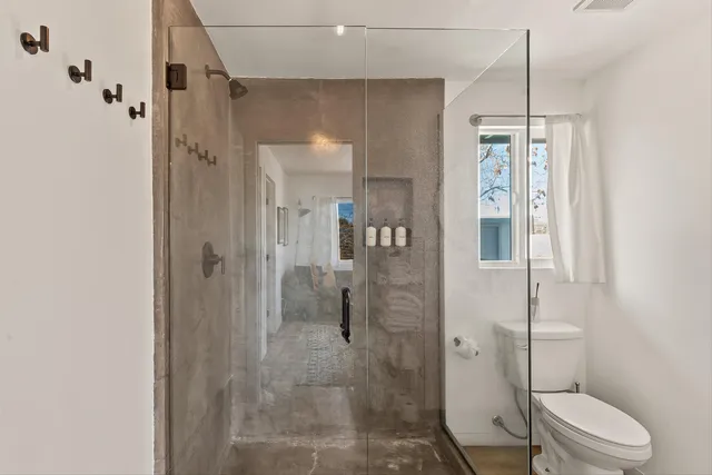 a bathroom with a shower and toilet