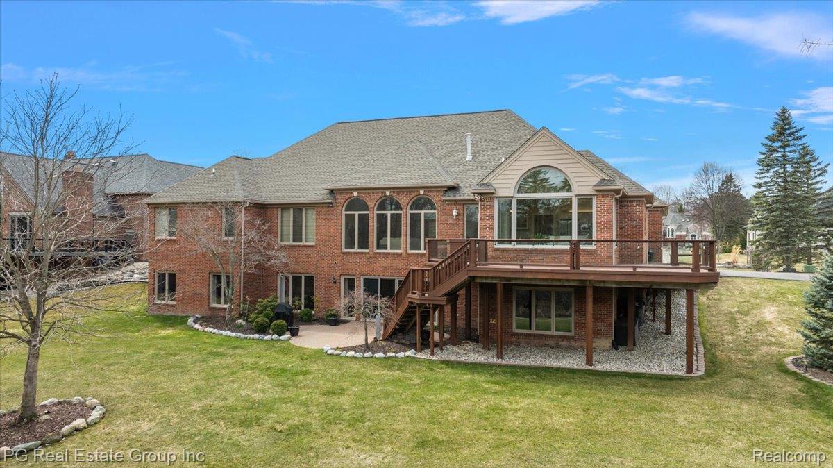 3571 Cedar Brook Drive Rochester, MI 48309 - Photo 6 of 57 Back of property featuring a wooden deck, brick siding, a patio area, and a yard