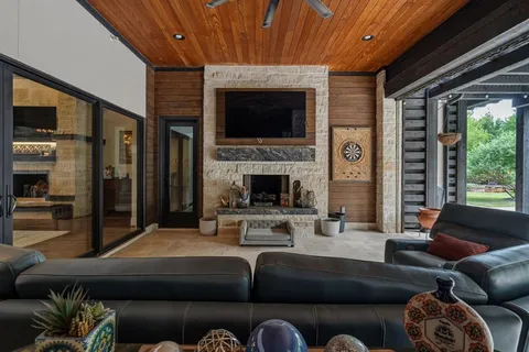 a living room with furniture fireplace and flat screen tv