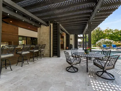 a view of a dinning table and chairs in patio