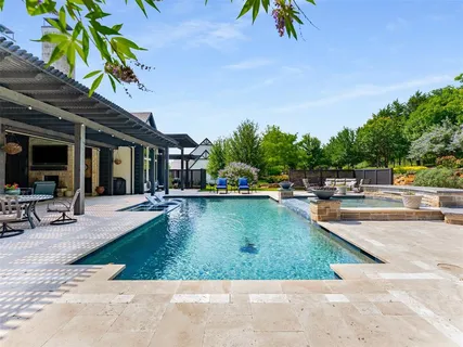 a view of a swimming pool with chairs