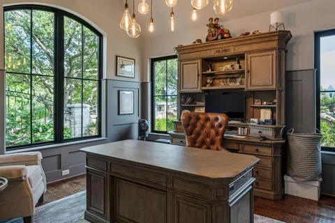 a kitchen with a table chairs and wooden floor