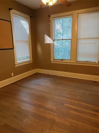 a view of room with window and wooden floor