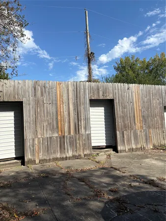 a view of a house with a wooden fence