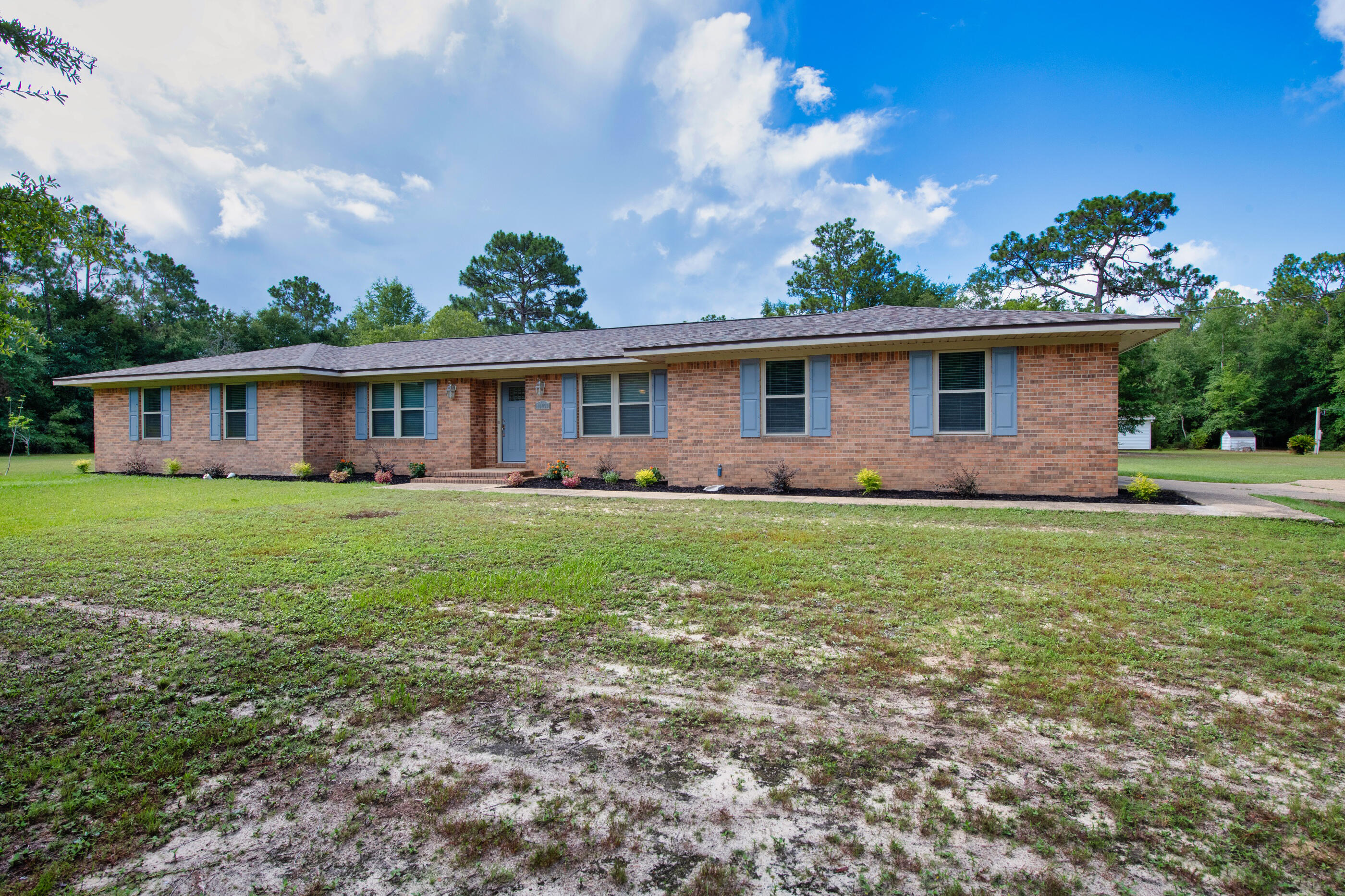 10099 Bellbrook Road Milton, FL 32583 - Photo 1 of 49 a front view of house with yard and green space