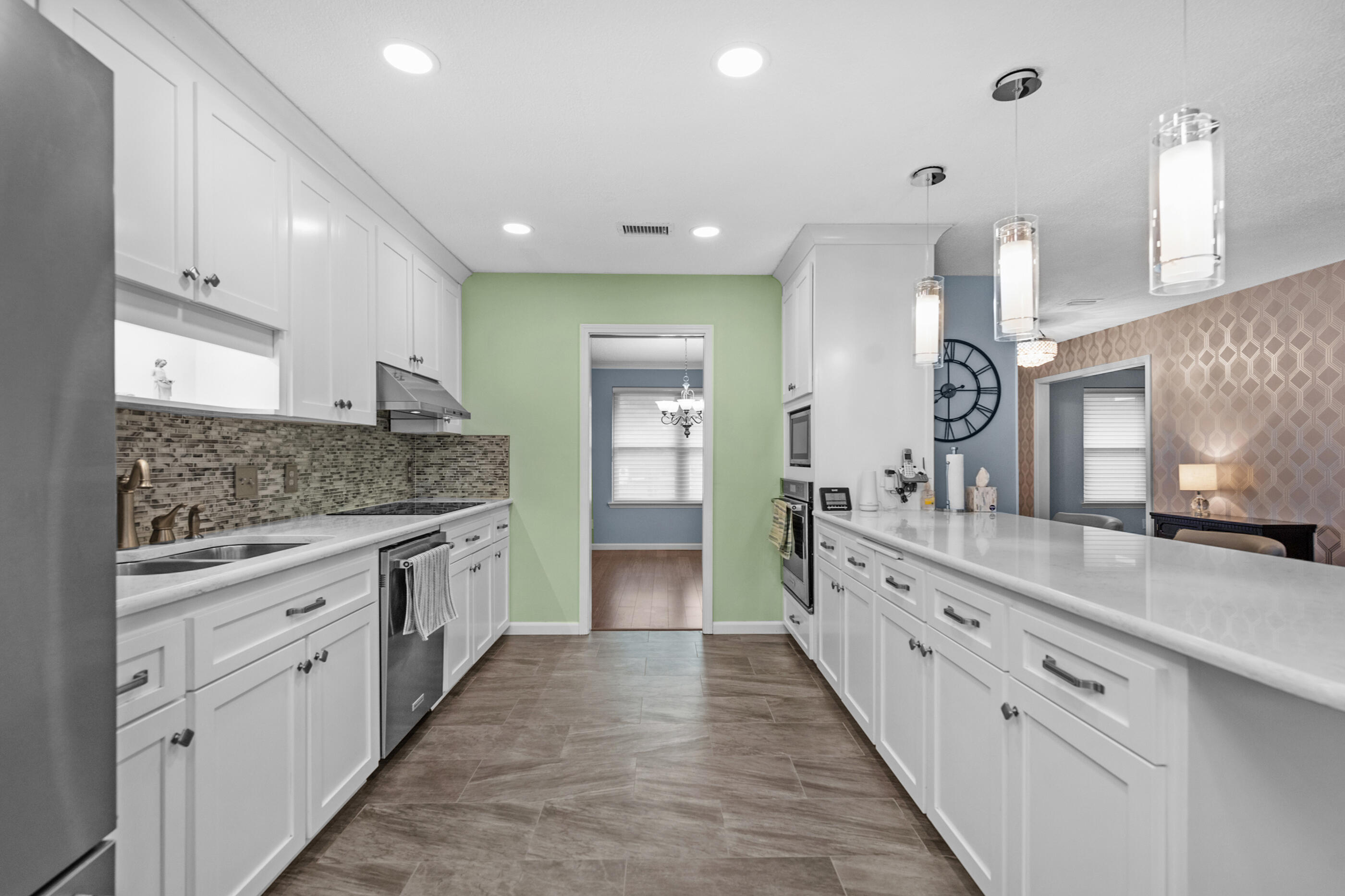 10099 Bellbrook Road Milton, FL 32583 - Photo 13 of 49 a large kitchen with granite countertop a large counter top and stainless steel appliances