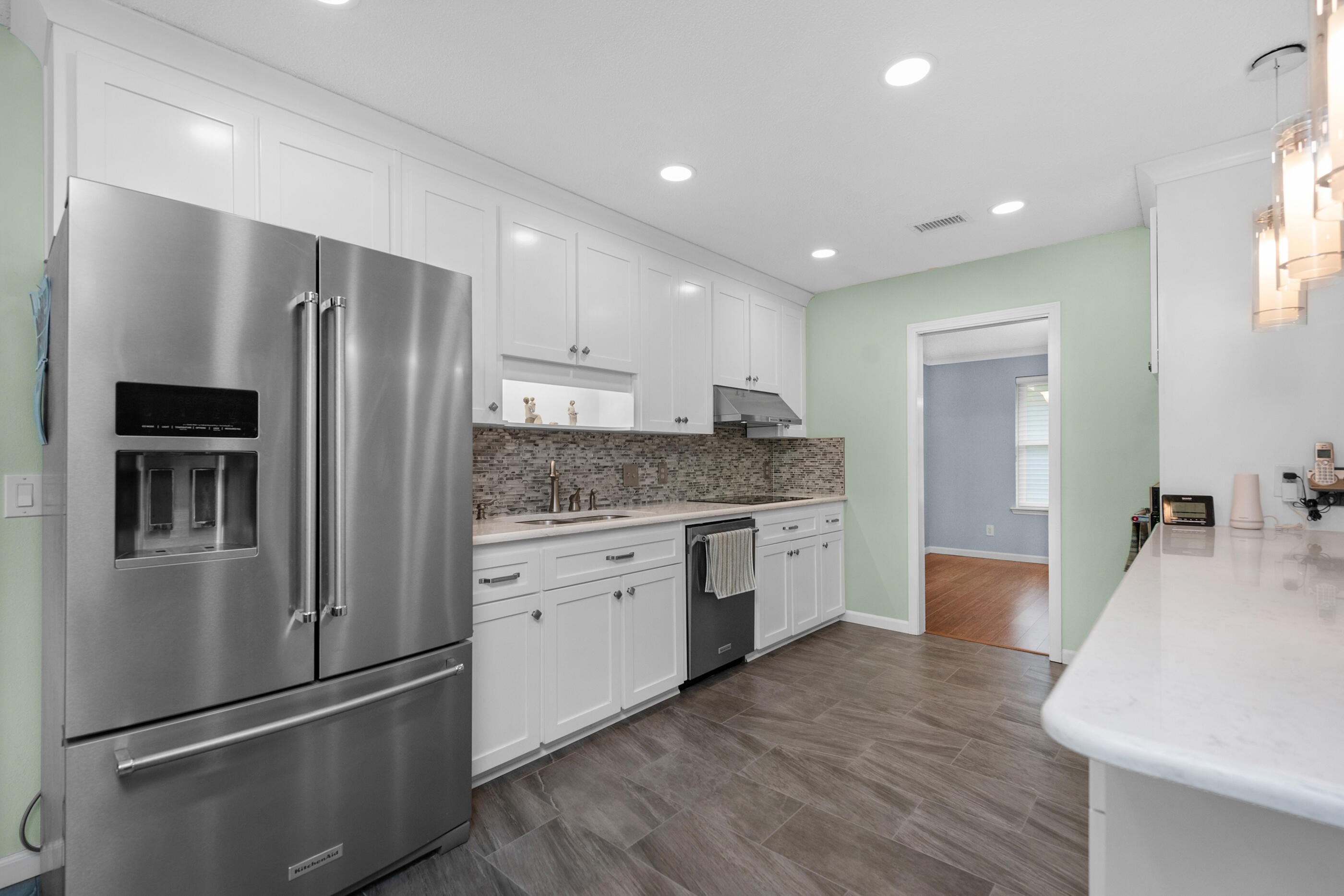 10099 Bellbrook Road Milton, FL 32583 - Photo 14 of 49 a kitchen with a refrigerator and a sink