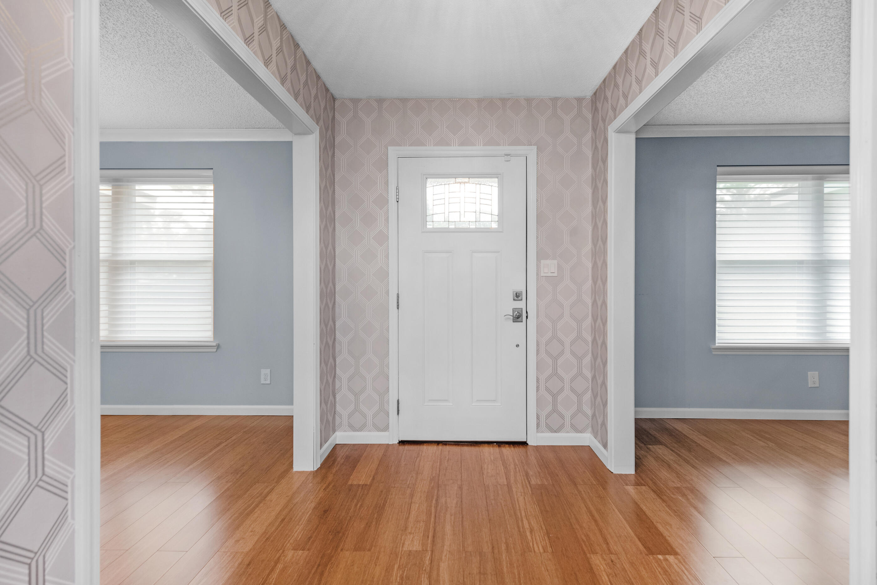 10099 Bellbrook Road Milton, FL 32583 - Photo 17 of 49 a view of an empty room with wooden floor and a window
