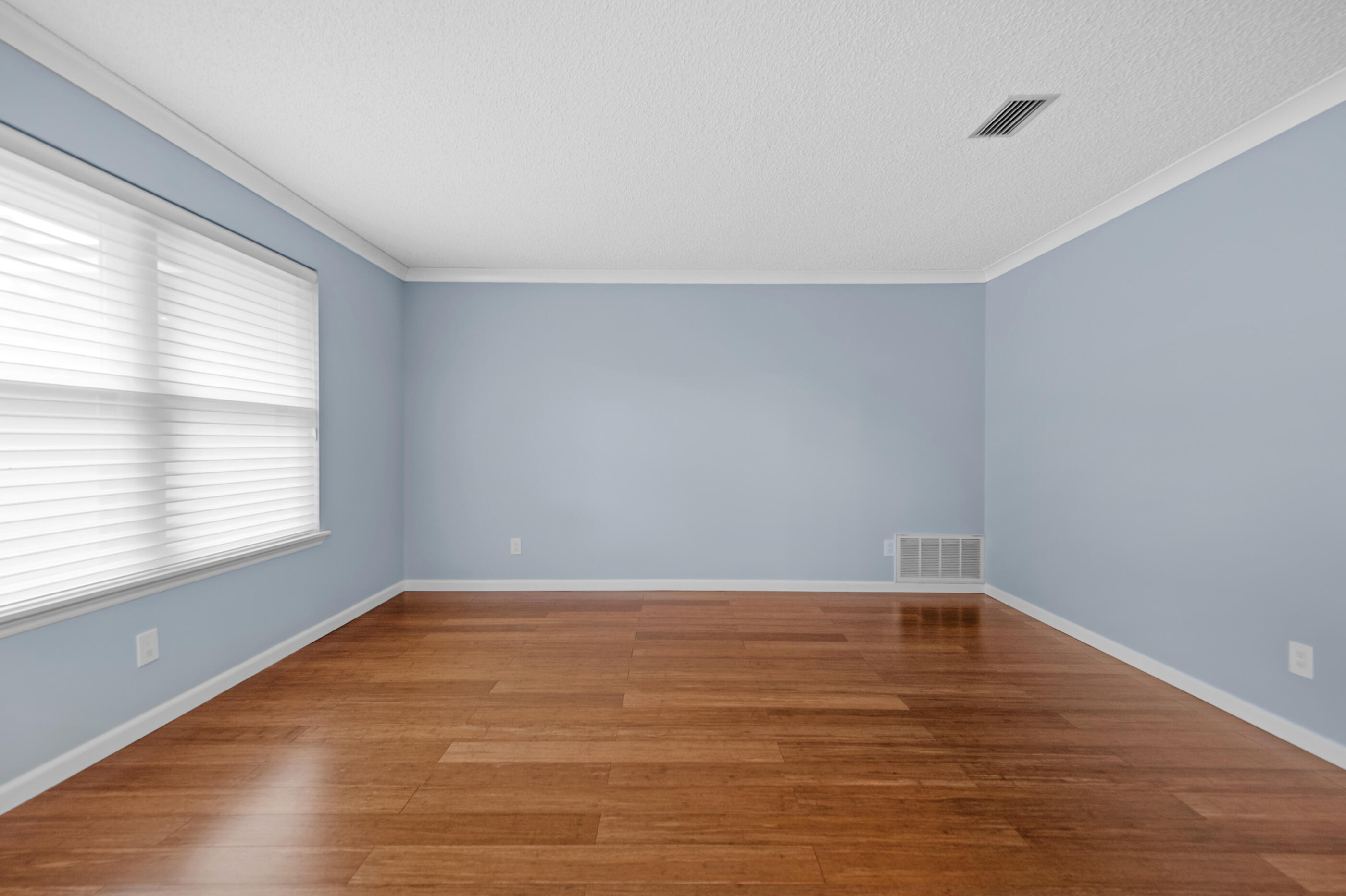 10099 Bellbrook Road Milton, FL 32583 - Photo 19 of 49 a view of an empty room with wooden floor and a window