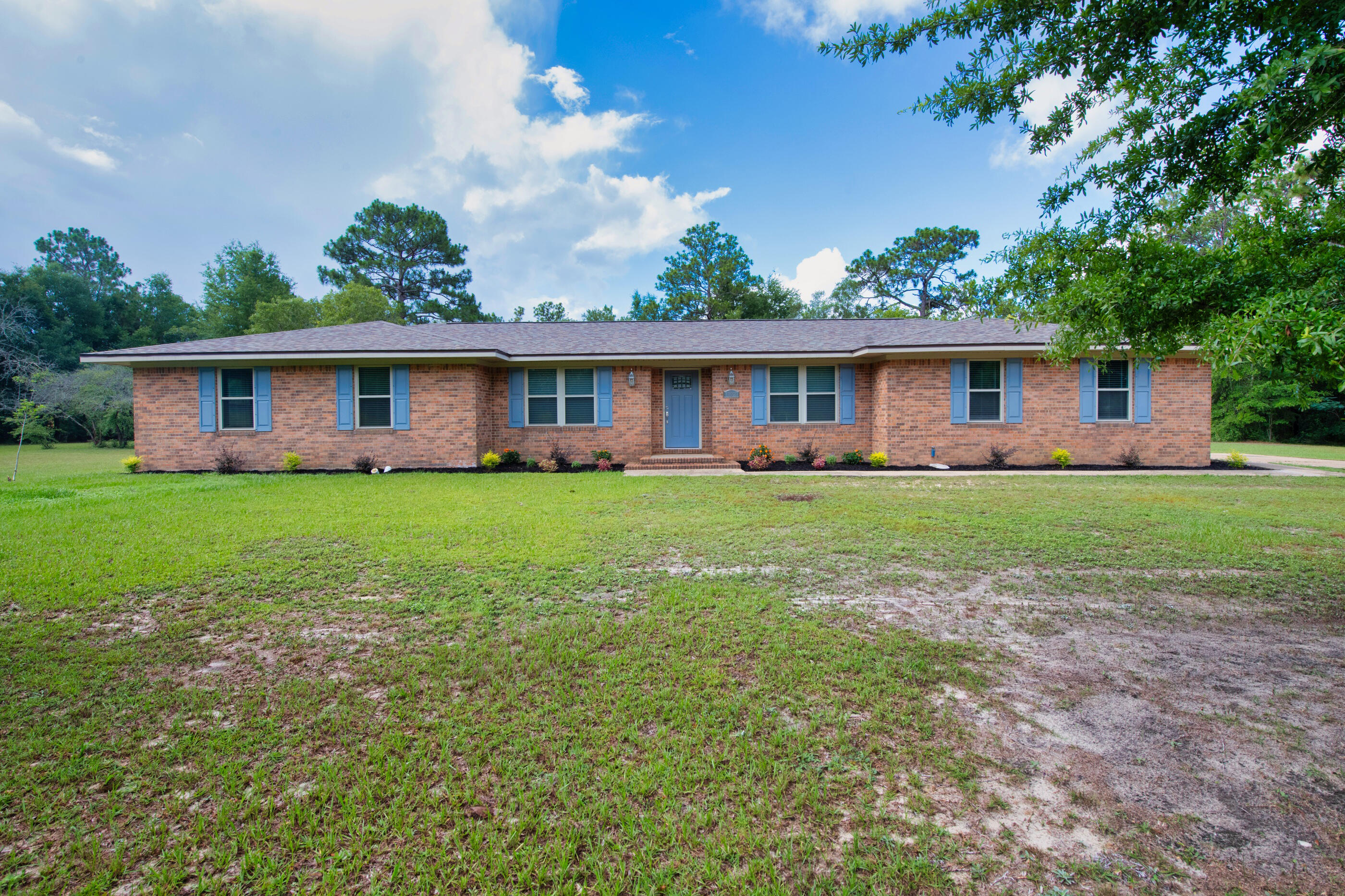 10099 Bellbrook Road Milton, FL 32583 - Photo 2 of 49 a front view of house with yard and green space