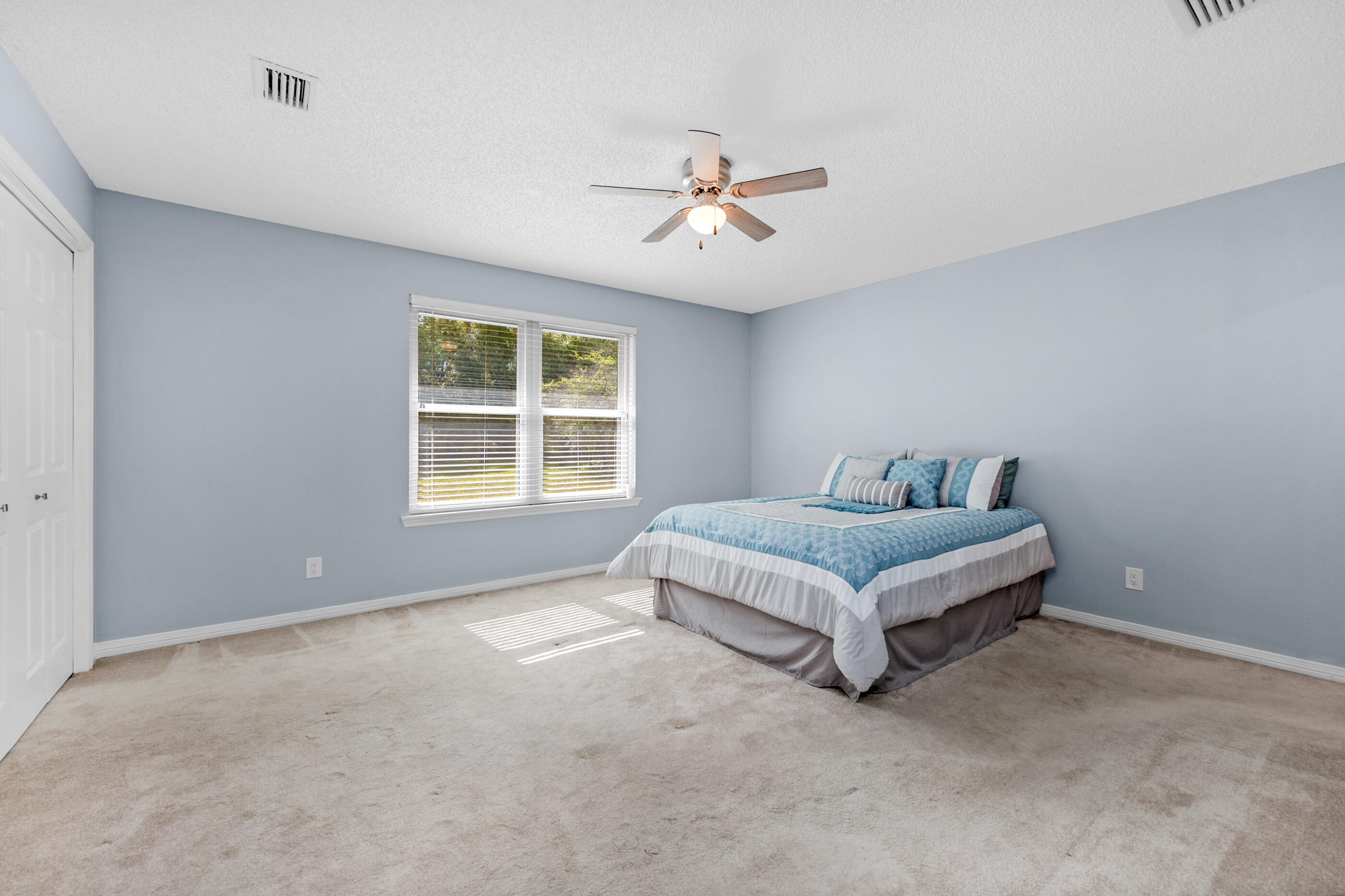 10099 Bellbrook Road Milton, FL 32583 - Photo 23 of 49 a bed sitting in a spacious bedroom next to a window