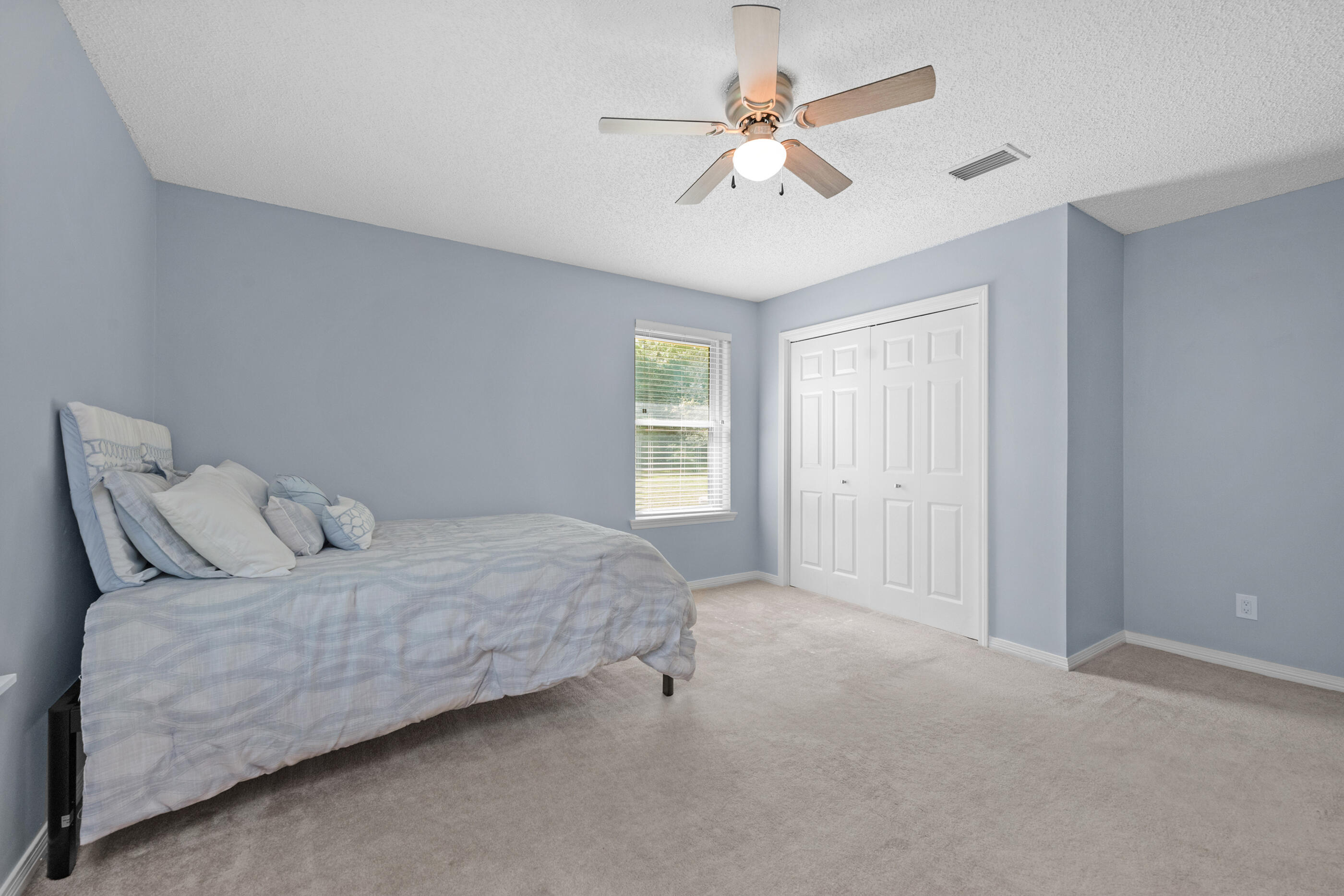 10099 Bellbrook Road Milton, FL 32583 - Photo 28 of 49 a bedroom with a large bed and ceiling fan