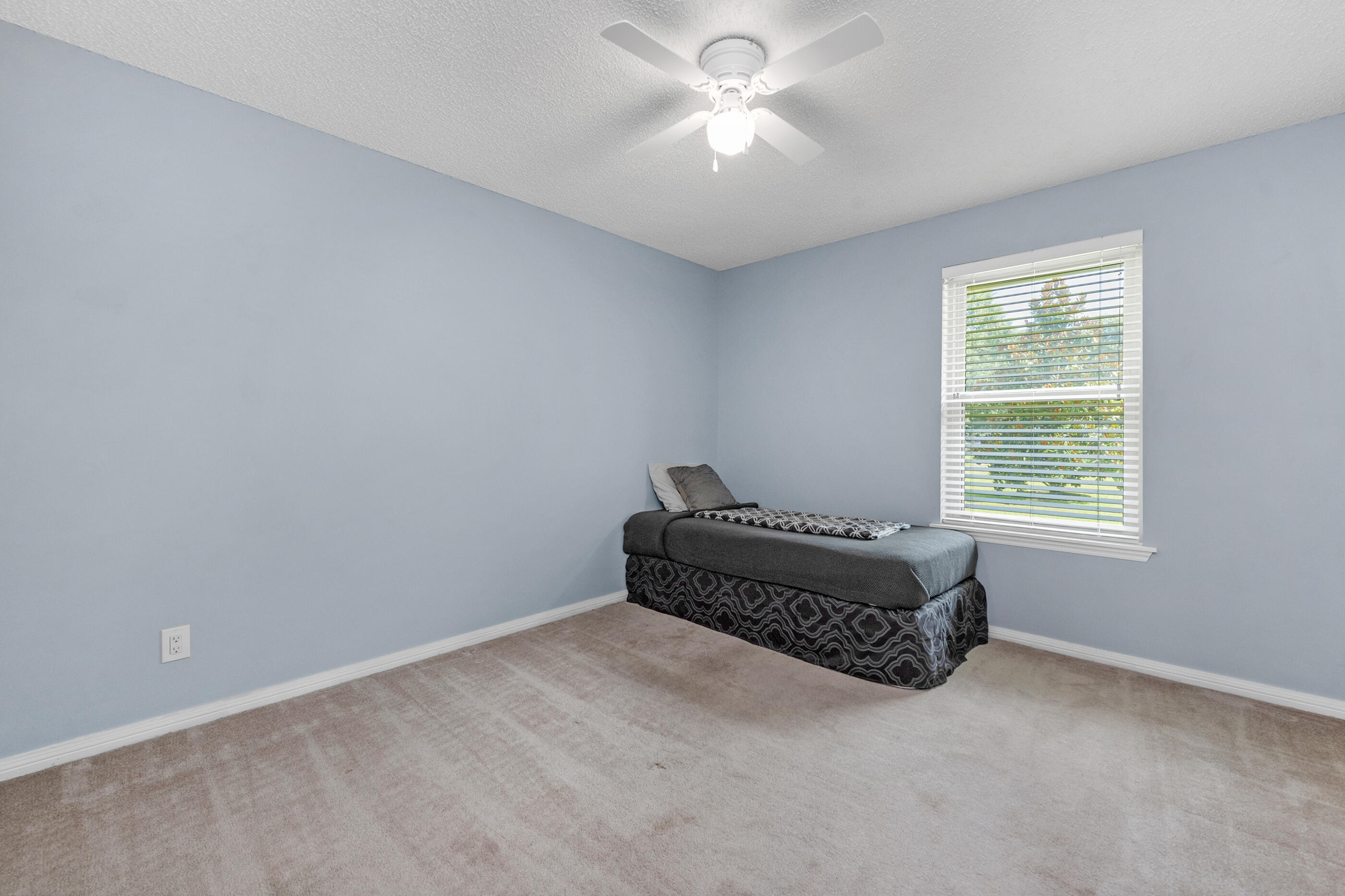 10099 Bellbrook Road Milton, FL 32583 - Photo 29 of 49 a spacious bedroom with a bed and a window