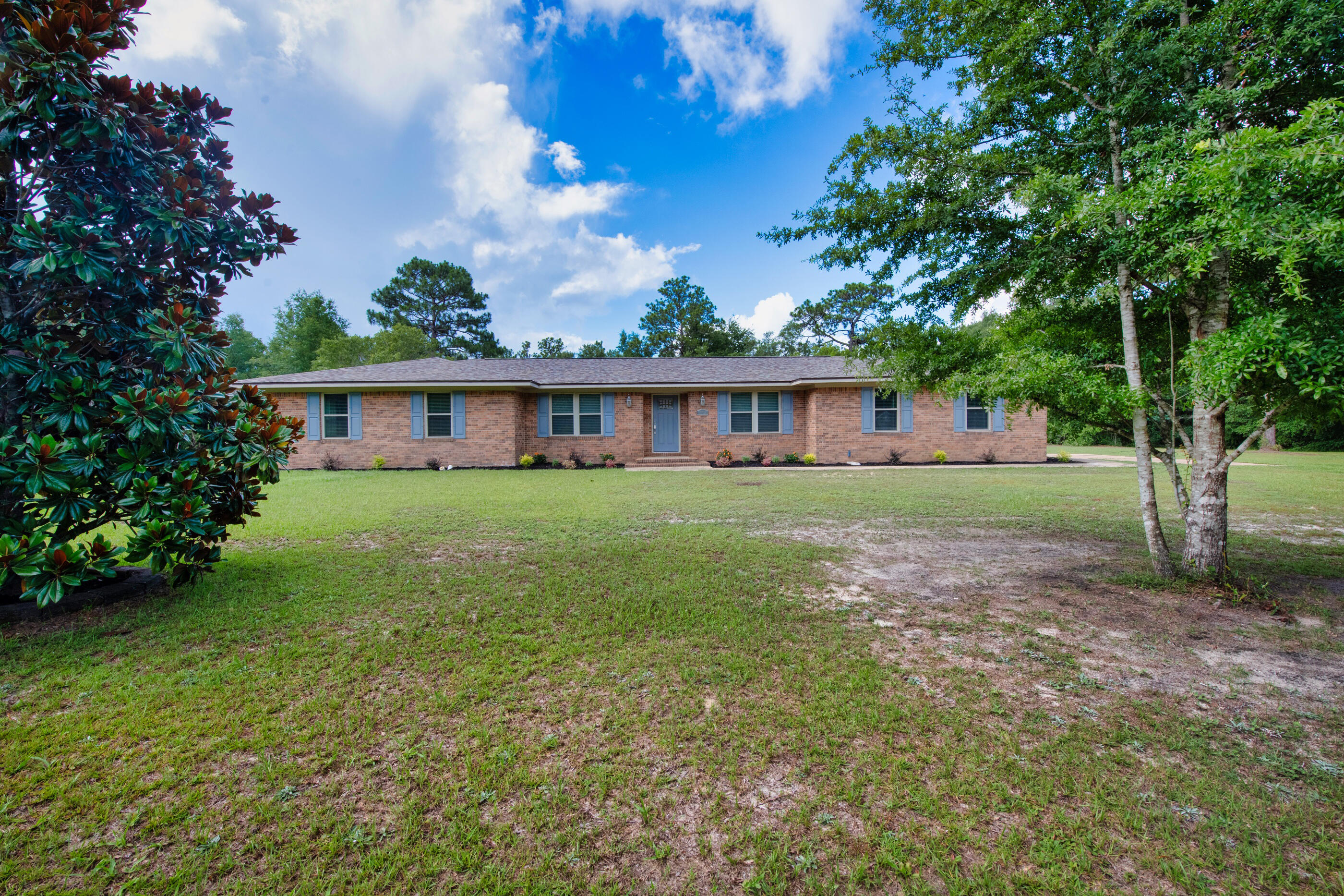 10099 Bellbrook Road Milton, FL 32583 - Photo 3 of 49 a view of a house with backyard and a tree