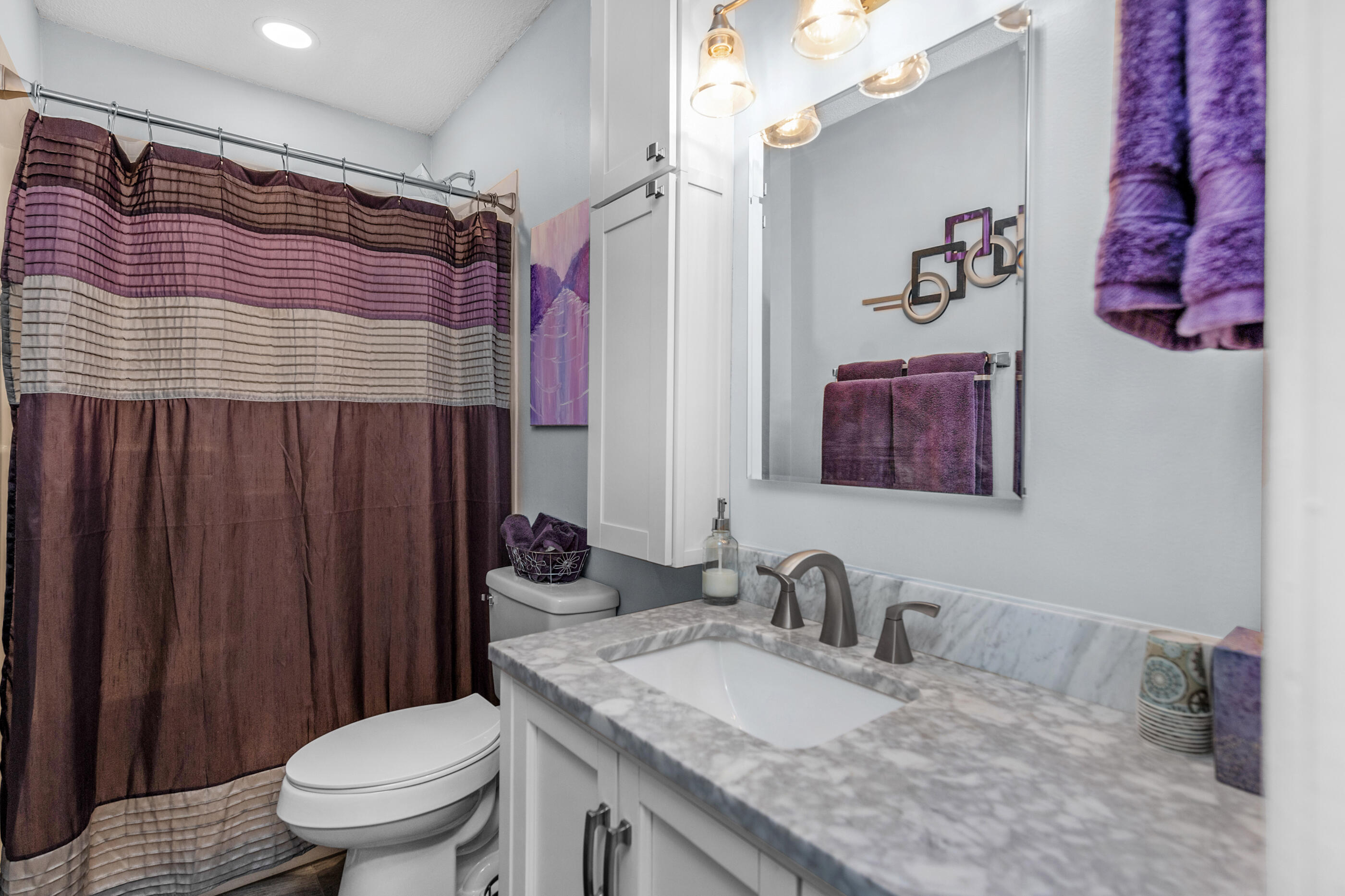 10099 Bellbrook Road Milton, FL 32583 - Photo 35 of 49 a bathroom with a granite countertop sink mirror vanity and toilet