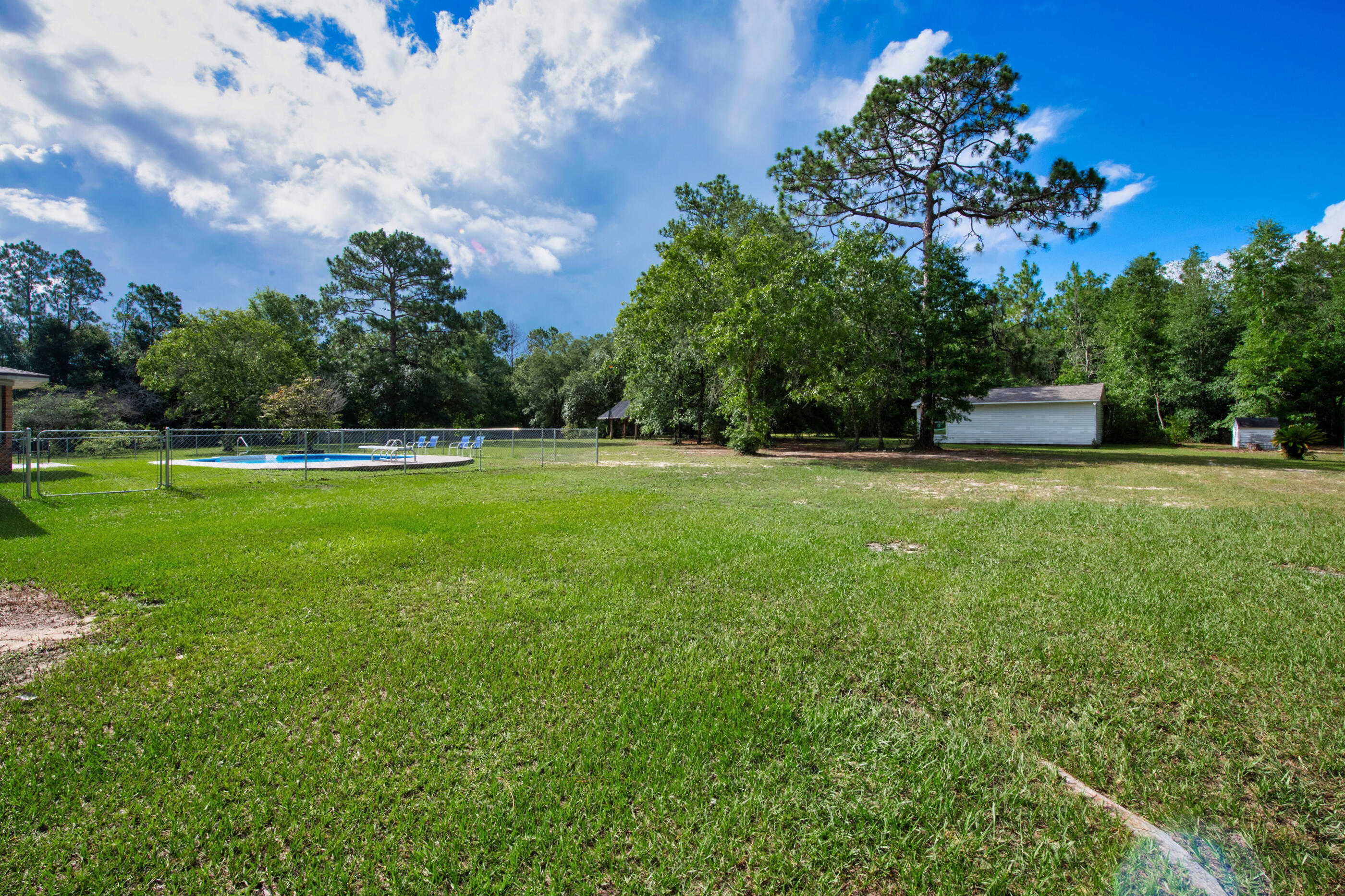 10099 Bellbrook Road Milton, FL 32583 - Photo 38 of 49 a view of a garden with a house