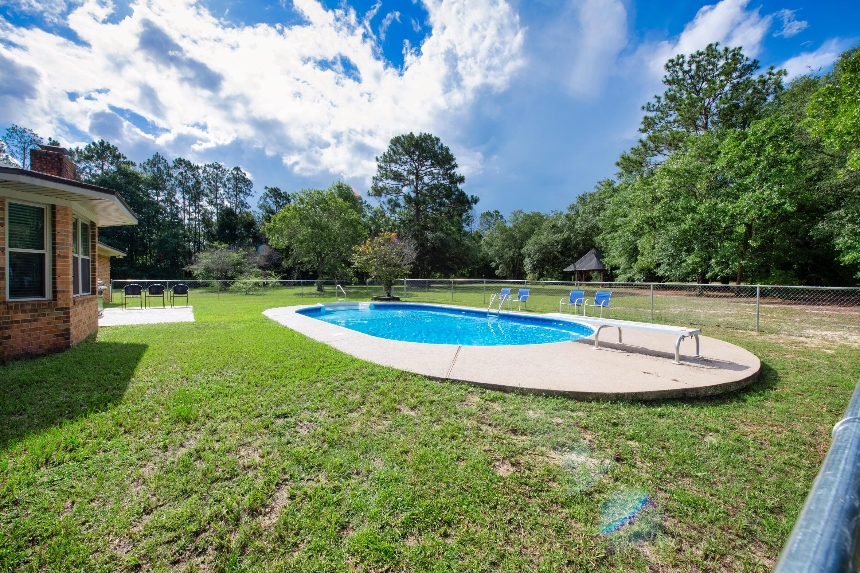10099 Bellbrook Road Milton, FL 32583 - Photo 39 of 49 a view of a swimming pool with a yard