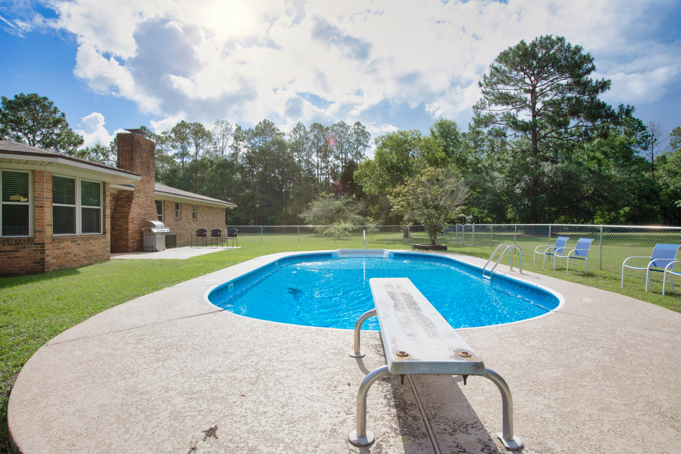 10099 Bellbrook Road Milton, FL 32583 - Photo 41 of 49 a view of a house with swimming pool and yard