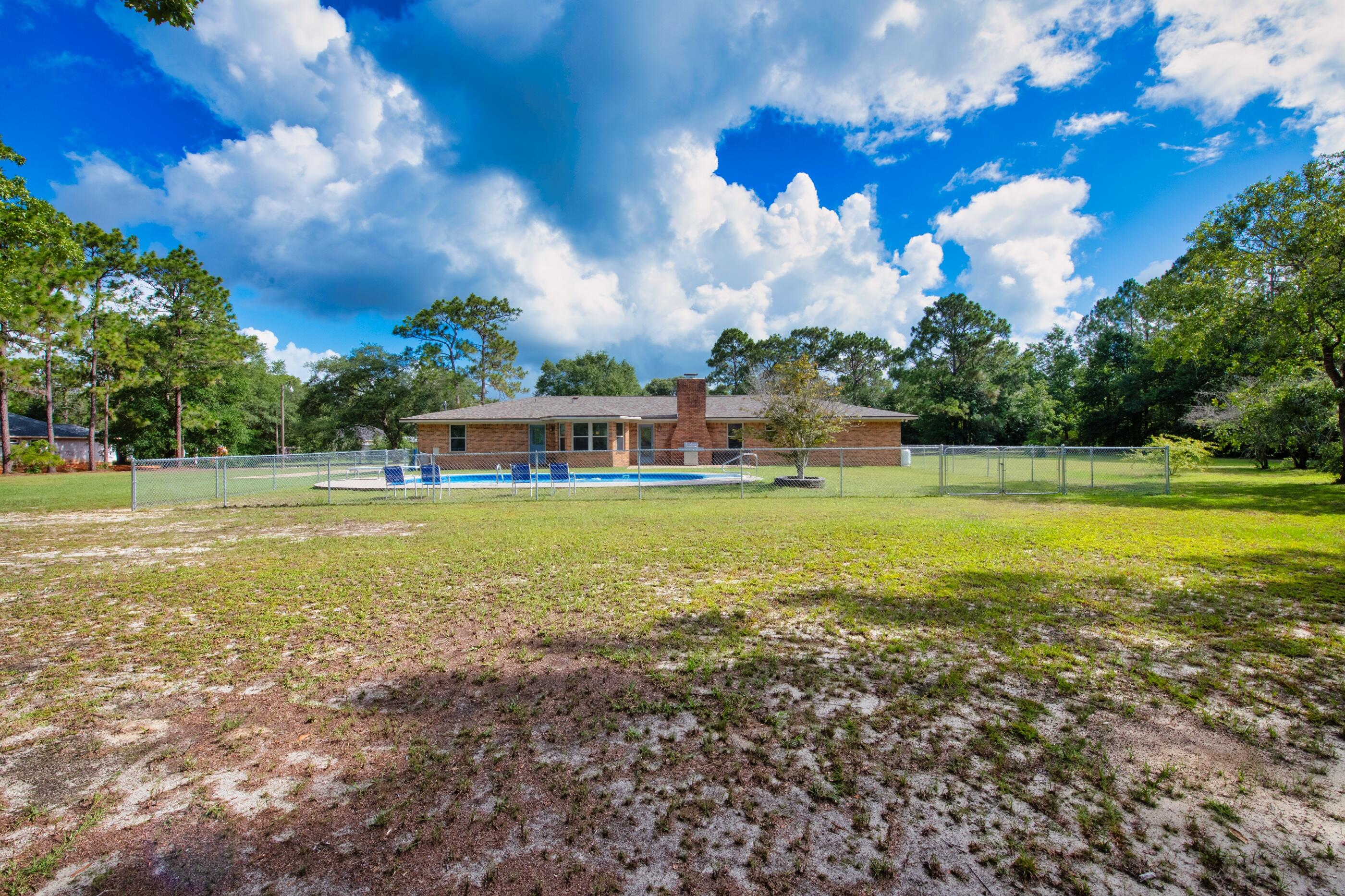 10099 Bellbrook Road Milton, FL 32583 - Photo 43 of 49 a view of a house with a big yard