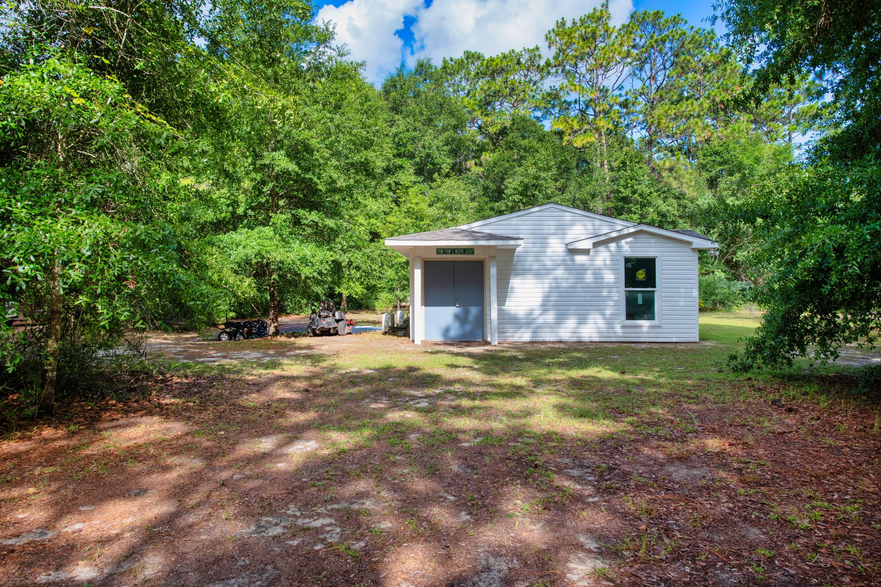 10099 Bellbrook Road Milton, FL 32583 - Photo 46 of 49 a backyard of a house with yard and outdoor seating