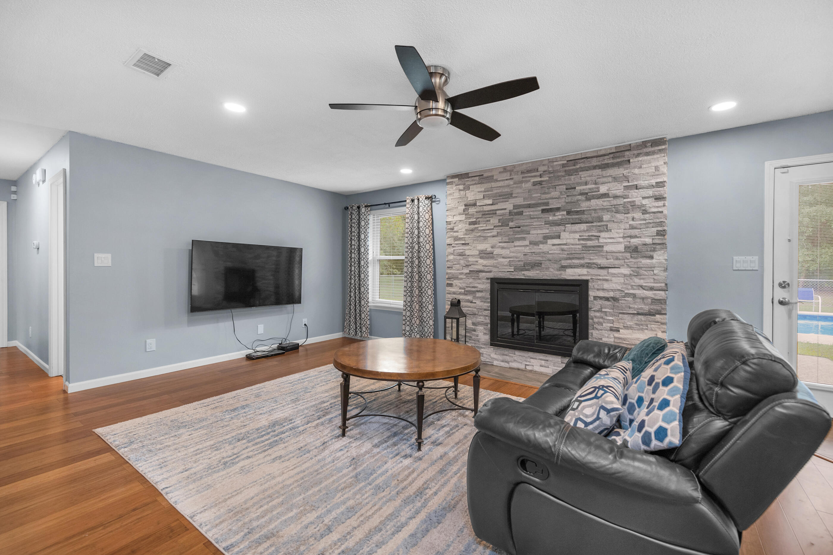 10099 Bellbrook Road Milton, FL 32583 - Photo 7 of 49 a living room with furniture and a fireplace