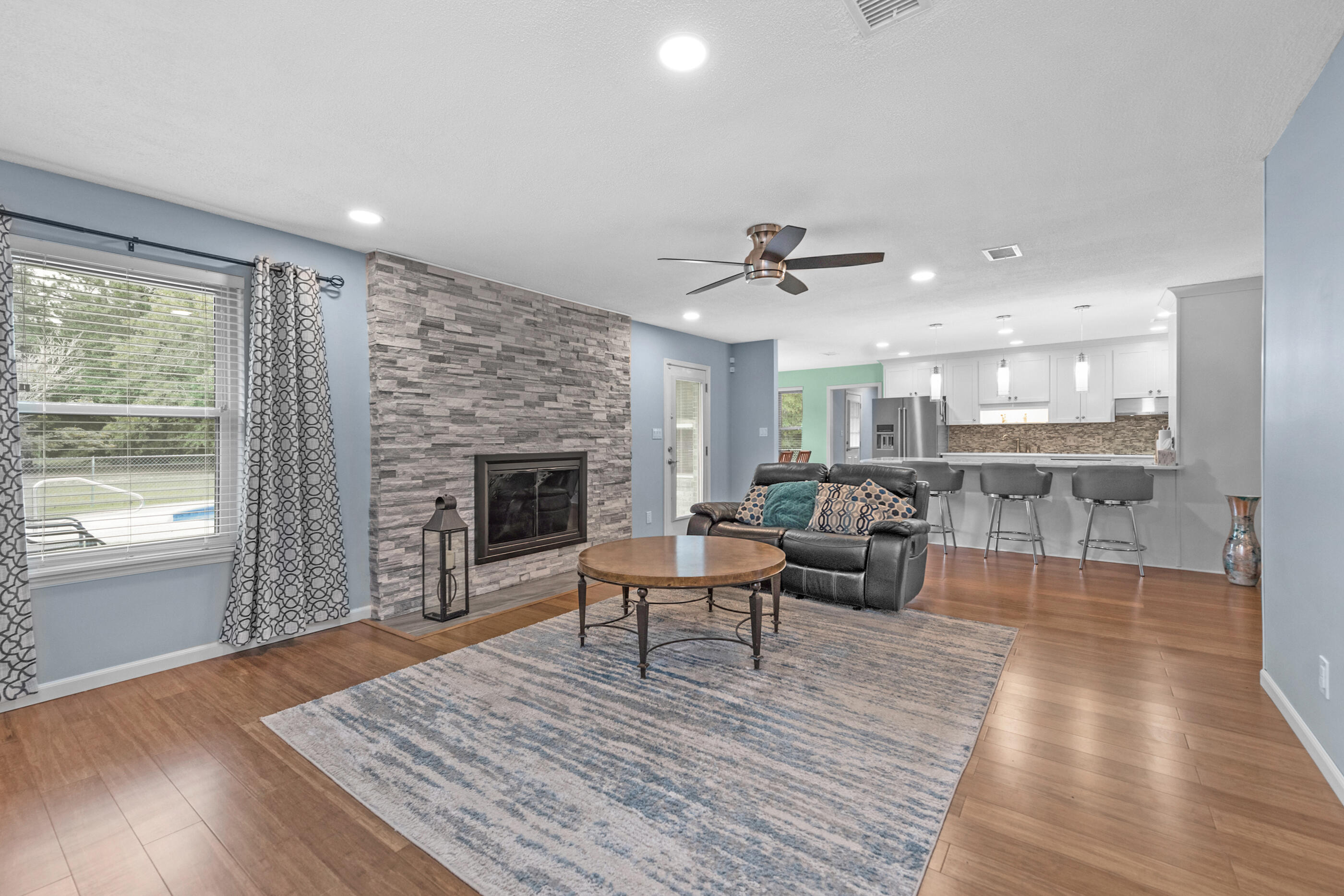 10099 Bellbrook Road Milton, FL 32583 - Photo 9 of 49 a living room with furniture wooden floor and a fireplace