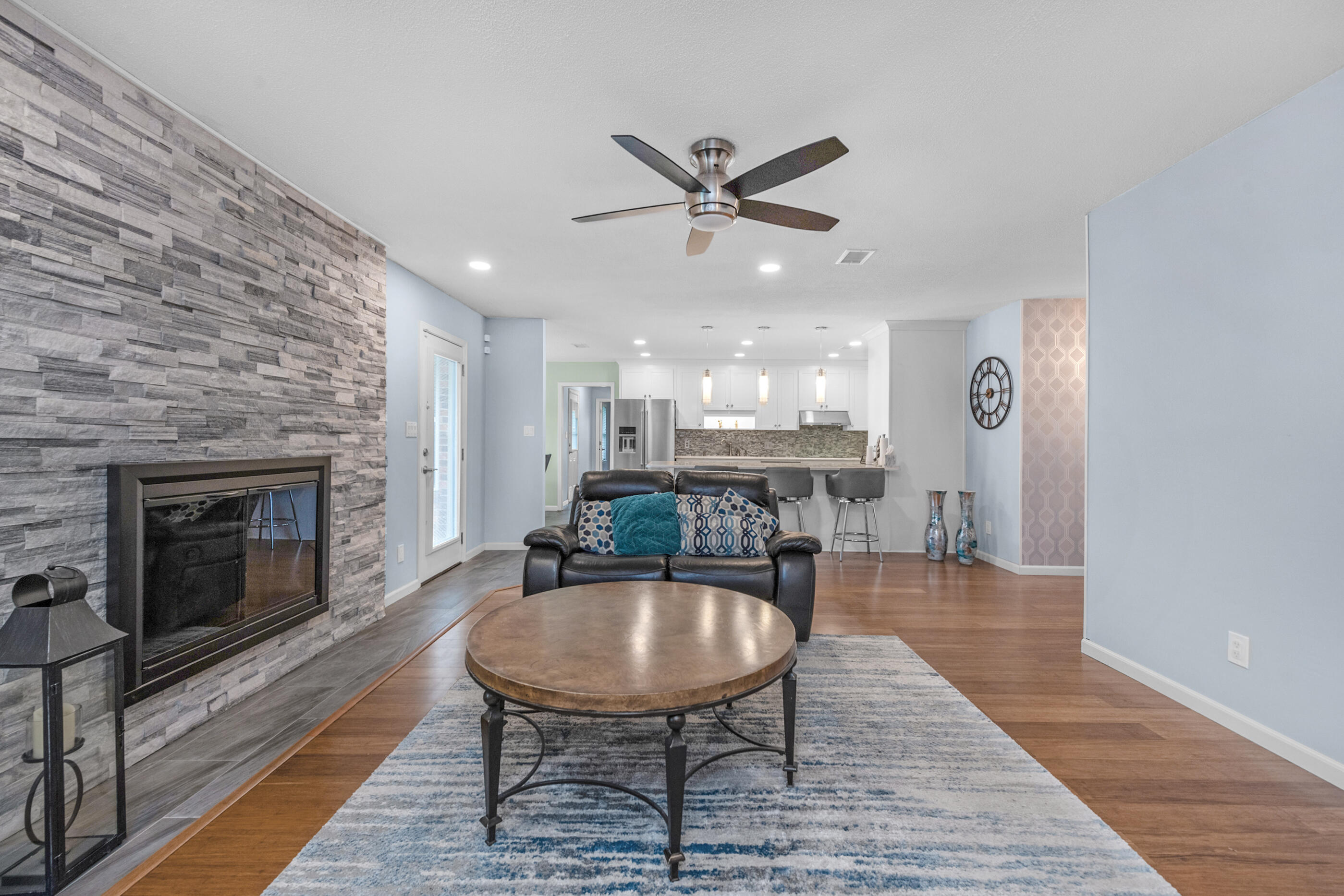 10099 Bellbrook Road Milton, FL 32583 - Photo 10 of 49 a dining room with furniture a fireplace and wooden floor